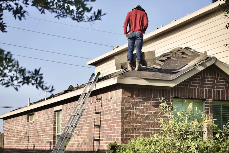 Professional roofer working on a residential roof in Dannersville